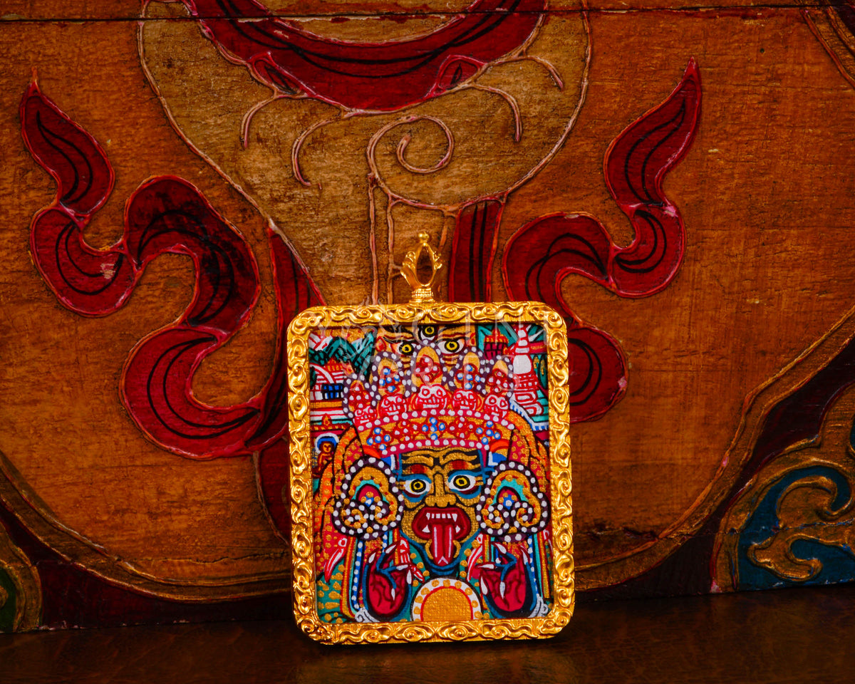 Hand-painted Zhaji Lhamo Ghau pendant in a gold-tone frame, handcrafted in Nepal using traditional Tibetan miniature painting techniques.
