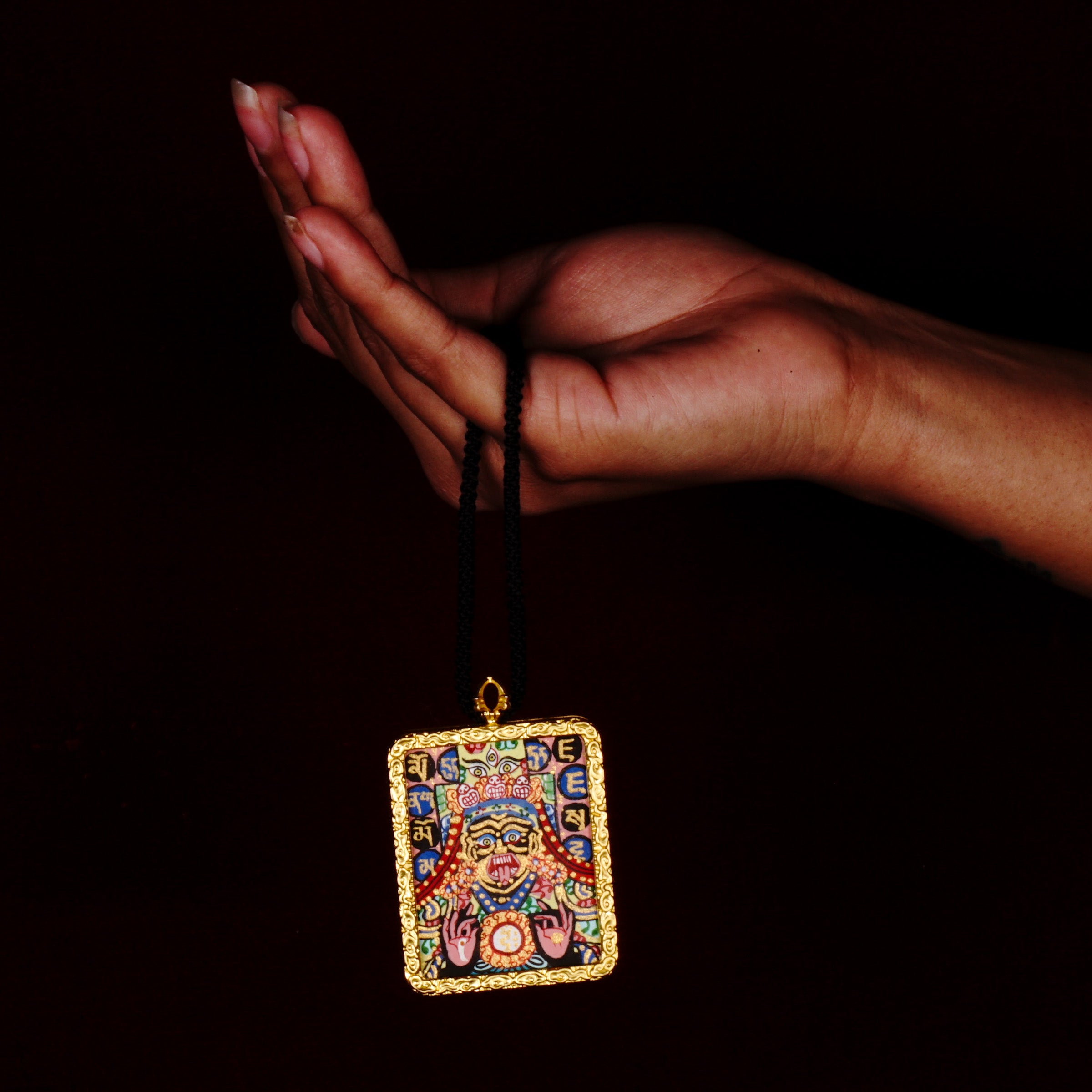 Hand-painted Goddess Kali miniature Thangka pendant in gold-accented copper Ghau locket with black cord.
