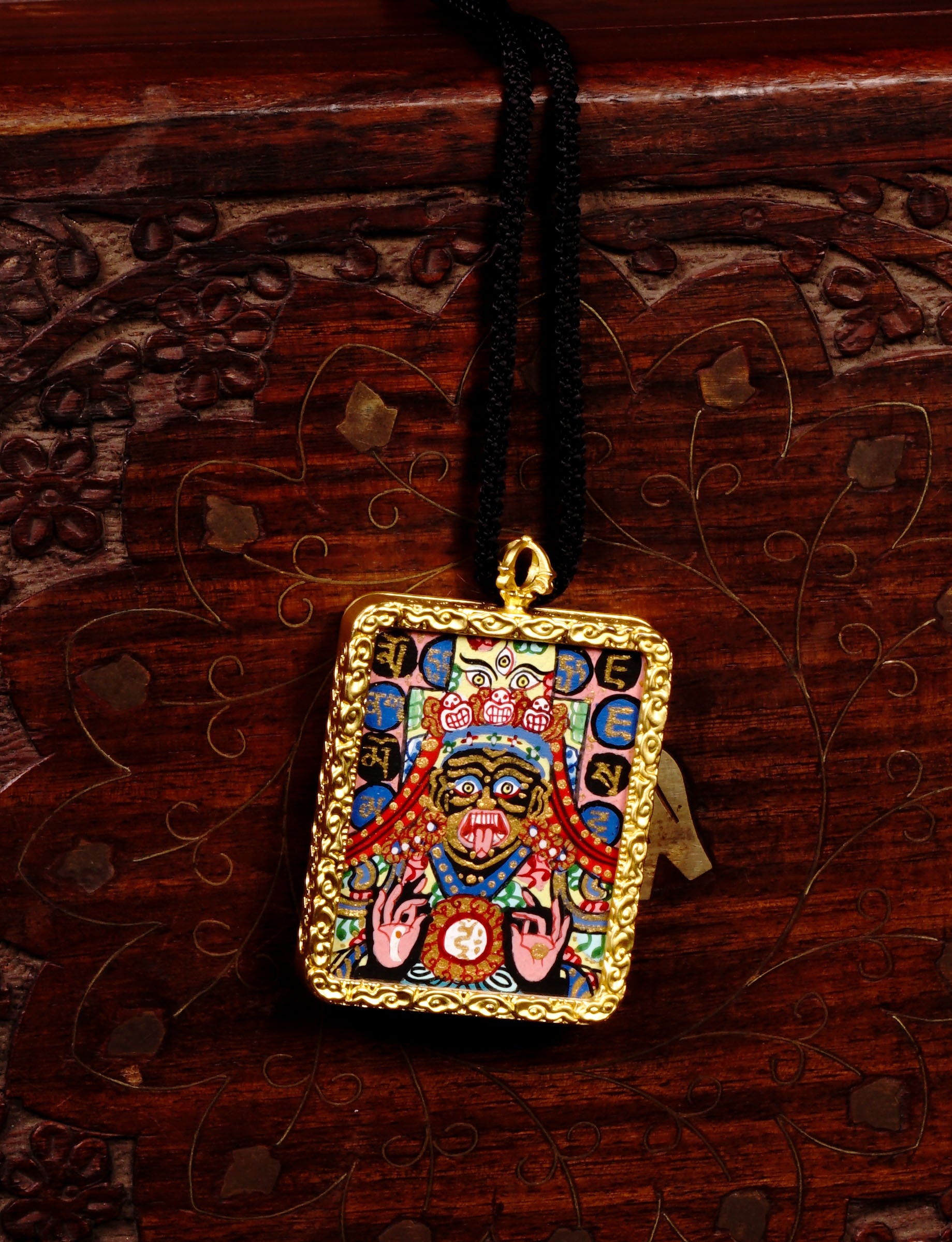 Hand-painted Goddess Kali miniature Thangka pendant in gold-accented copper Ghau locket with black cord.