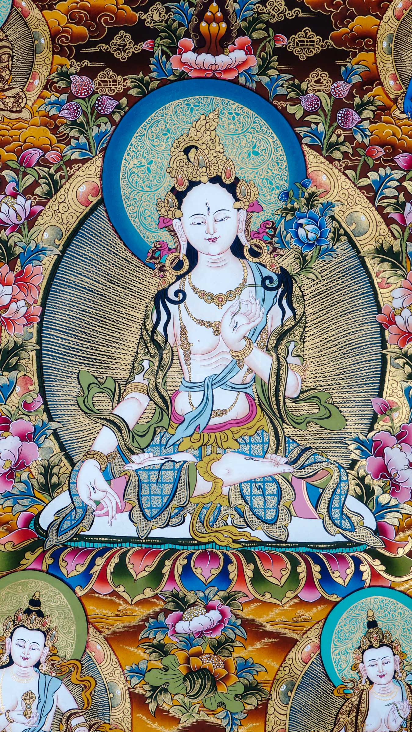 Tibetan thangka of White Tara seated on a lotus throne with seven eyes of wisdom, surrounded by attendant forms, hand-painted with traditional Himalayan Buddhist iconography