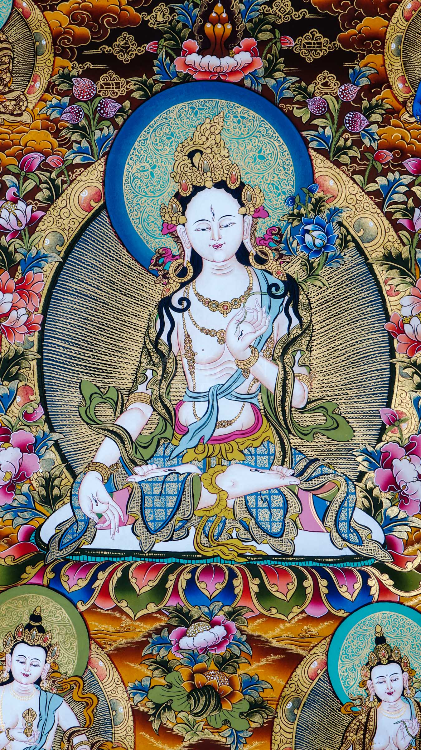 Tibetan thangka of White Tara seated on a lotus throne with seven eyes of wisdom, surrounded by attendant forms, hand-painted with traditional Himalayan Buddhist iconography