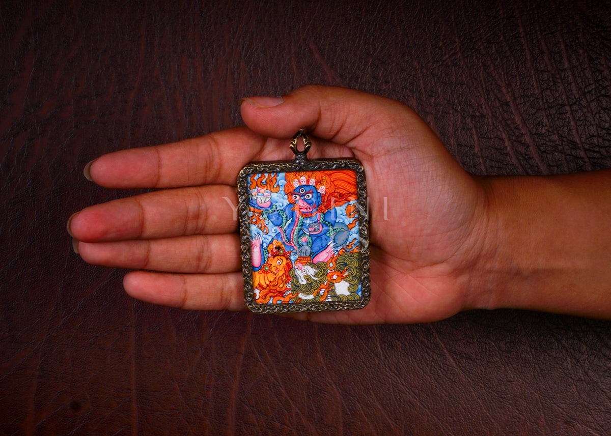 Hand-painted Black Zambhala Ghau pendant in an antique-style metal frame, handcrafted in Nepal using traditional Tibetan miniature painting techniques.