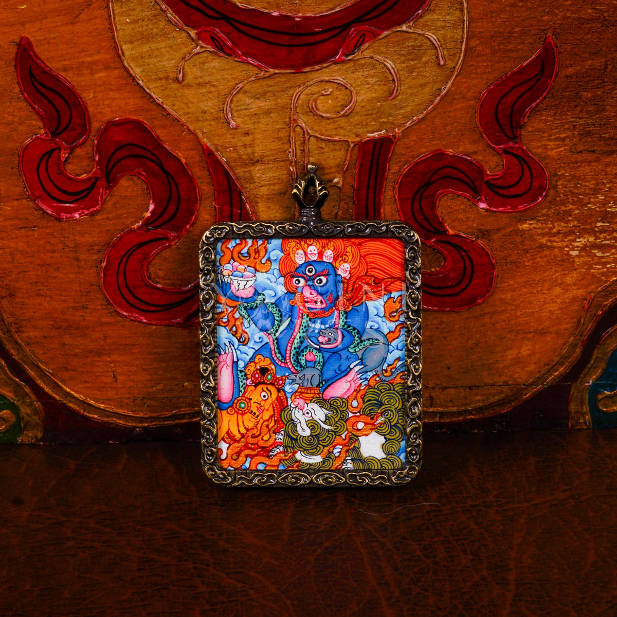 Hand-painted Black Zambhala Ghau pendant in an antique-style metal frame, handcrafted in Nepal using traditional Tibetan miniature painting techniques.