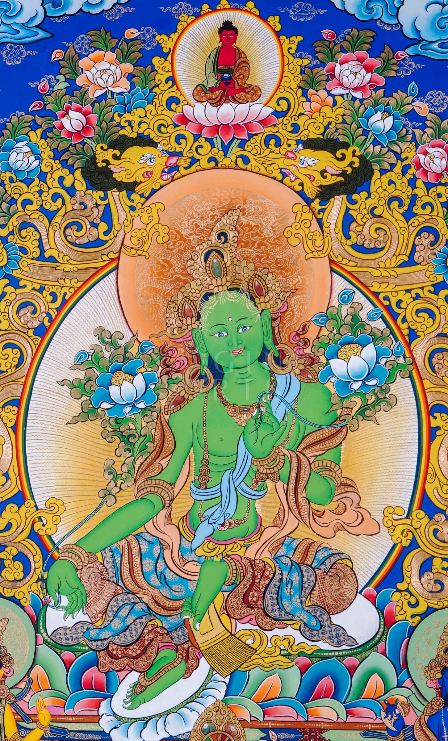 Green Tara seated on a lotus throne surrounded by sacred floral motifs and traditional Himalayan Buddhist ornamentation.