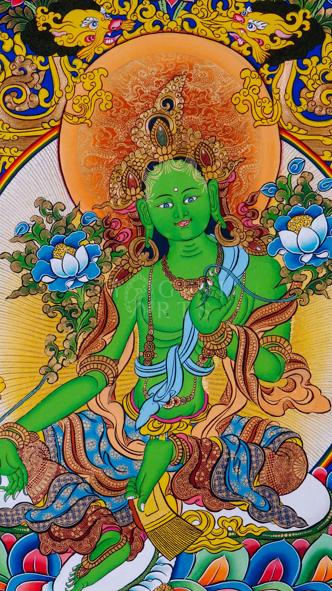 Green Tara seated on a lotus throne surrounded by sacred floral motifs and traditional Himalayan Buddhist ornamentation.