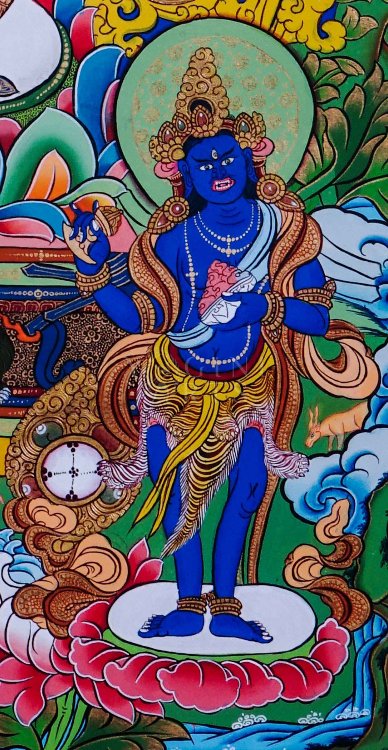 Green Tara seated on a lotus throne surrounded by sacred floral motifs and traditional Himalayan Buddhist ornamentation.