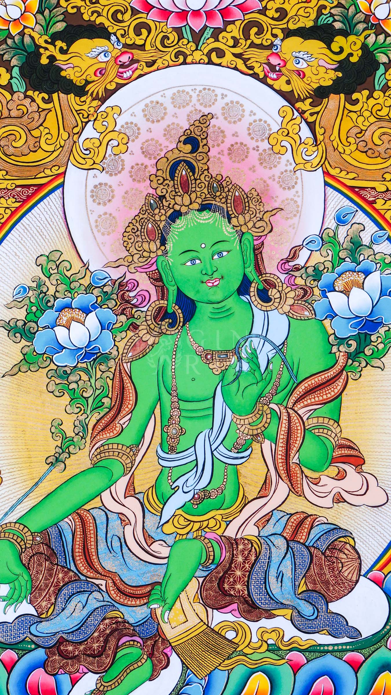 Green Tara seated on a lotus throne surrounded by floral ornamentation, sacred Buddhist symbolism, and traditional Himalayan decorative motifs.