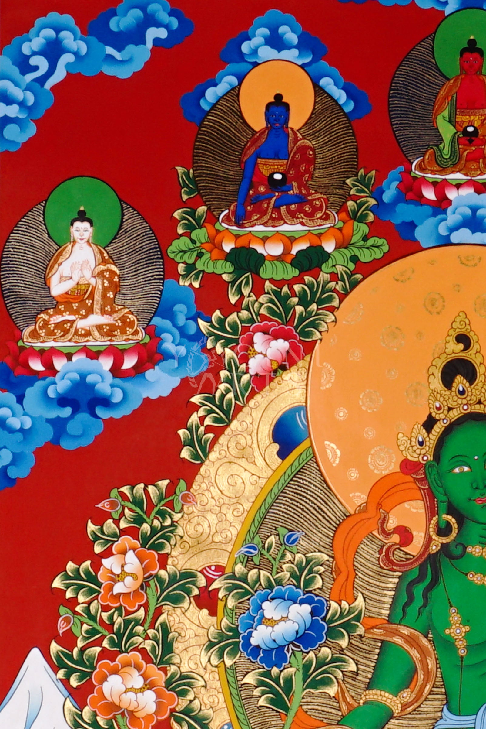 Green Tara thangka featuring the bodhisattva seated on a lotus throne with lotus flowers, surrounded by celestial figures and vibrant Himalayan landscape.