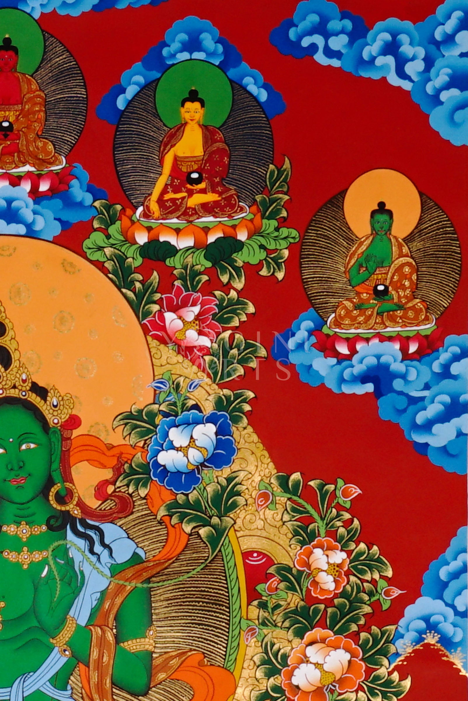 Green Tara thangka featuring the bodhisattva seated on a lotus throne with lotus flowers, surrounded by celestial figures and vibrant Himalayan landscape.