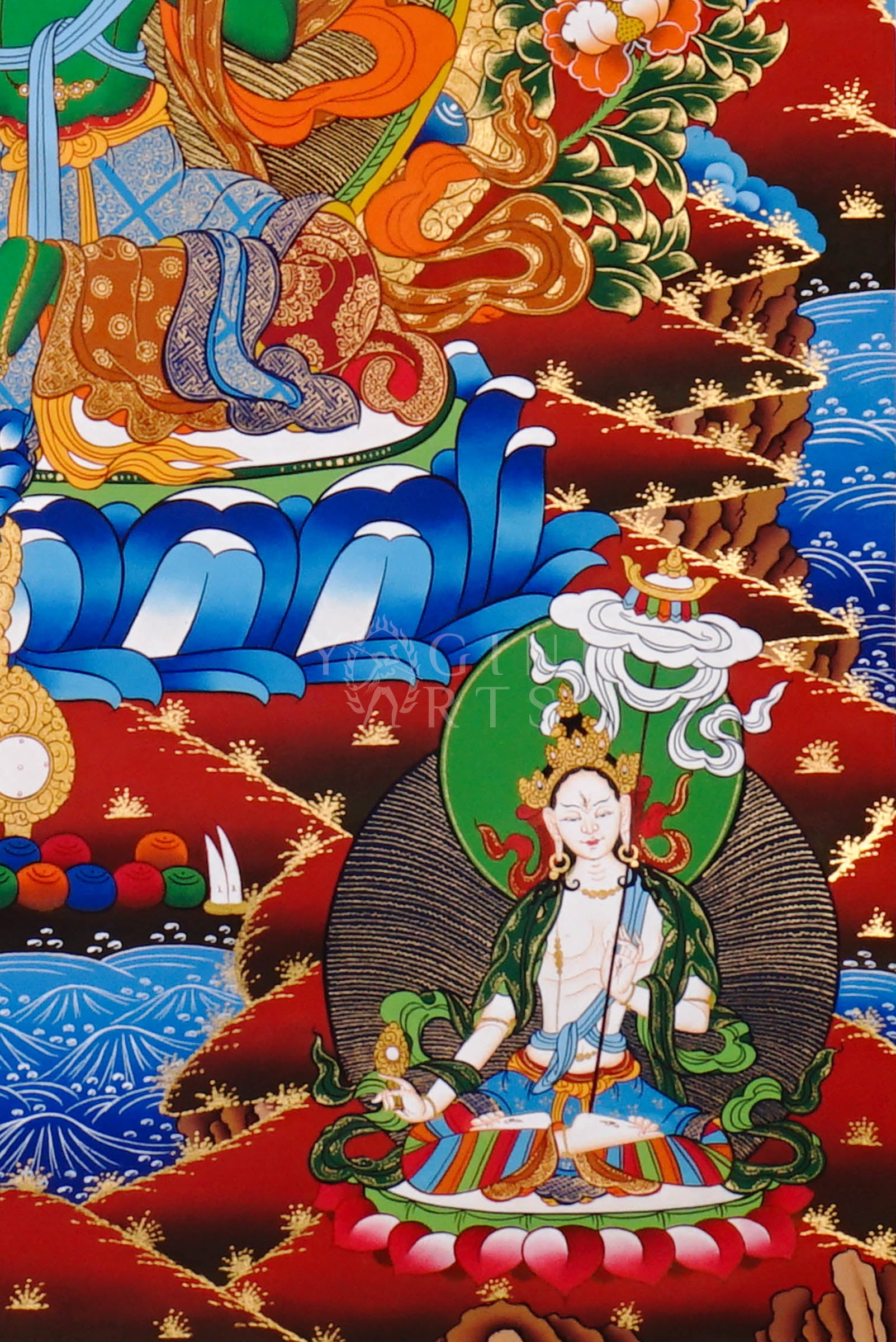 Green Tara thangka featuring the bodhisattva seated on a lotus throne with lotus flowers, surrounded by celestial figures and vibrant Himalayan landscape.