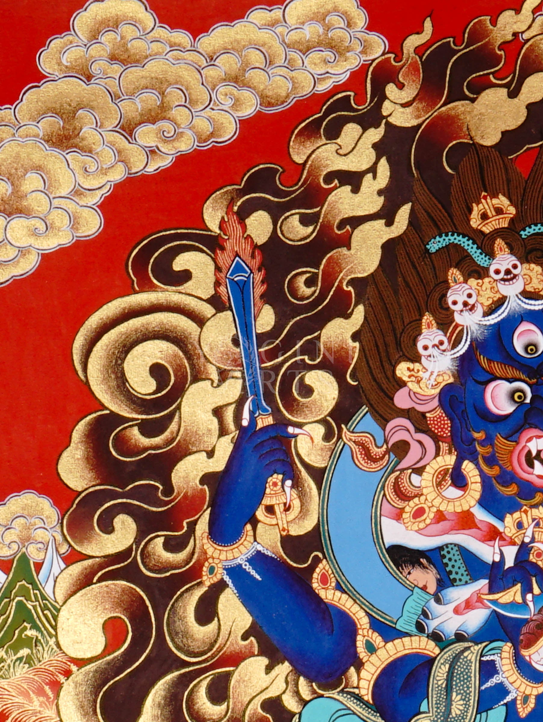 Mahakala thangka showing a fierce blue wrathful deity with multiple arms, surrounded by flames and standing on subdued figures in traditional Tibetan style.