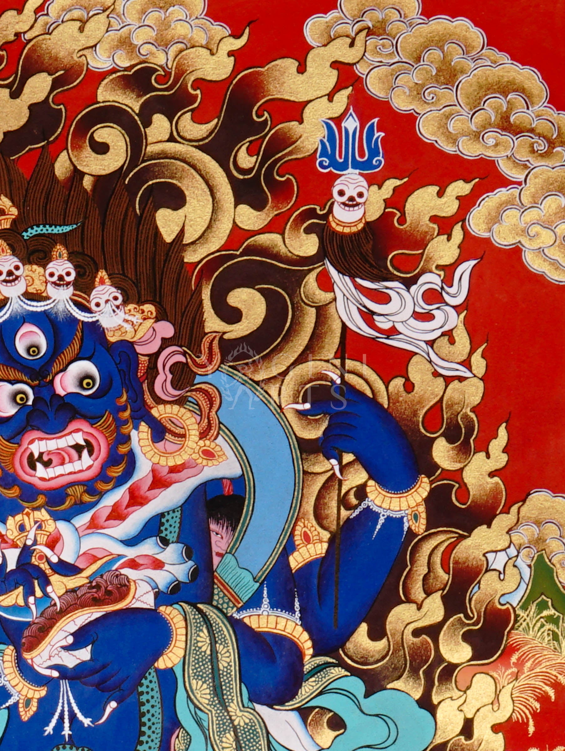 Mahakala thangka showing a fierce blue wrathful deity with multiple arms, surrounded by flames and standing on subdued figures in traditional Tibetan style.