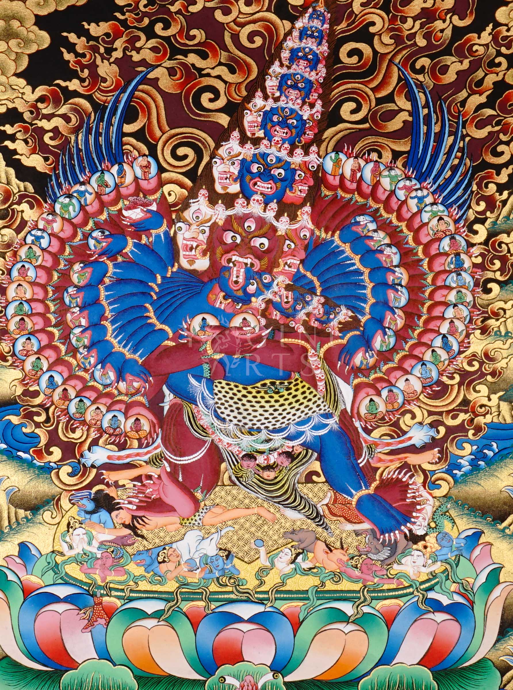 Heruka thangka showing a multi-headed, multi-armed wrathful tantric deity dancing on figures, surrounded by flames and intricate symbolic elements.