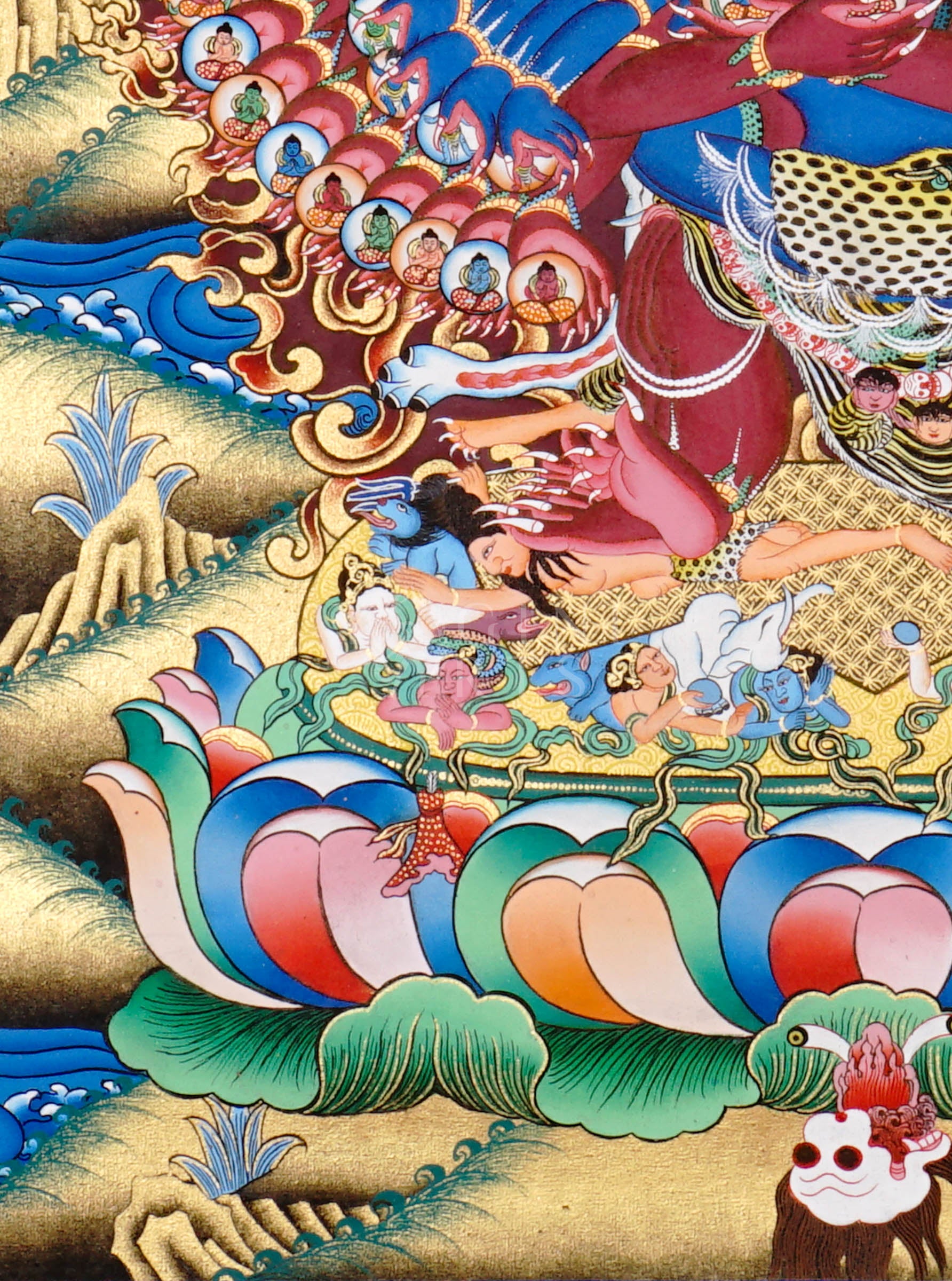 Heruka thangka showing a multi-headed, multi-armed wrathful tantric deity dancing on figures, surrounded by flames and intricate symbolic elements.