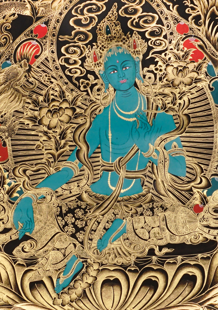 Gold-on-black Green Tara thangka showing the Buddhist goddess seated on a lotus throne surrounded by intricate gold floral and bird motifs.