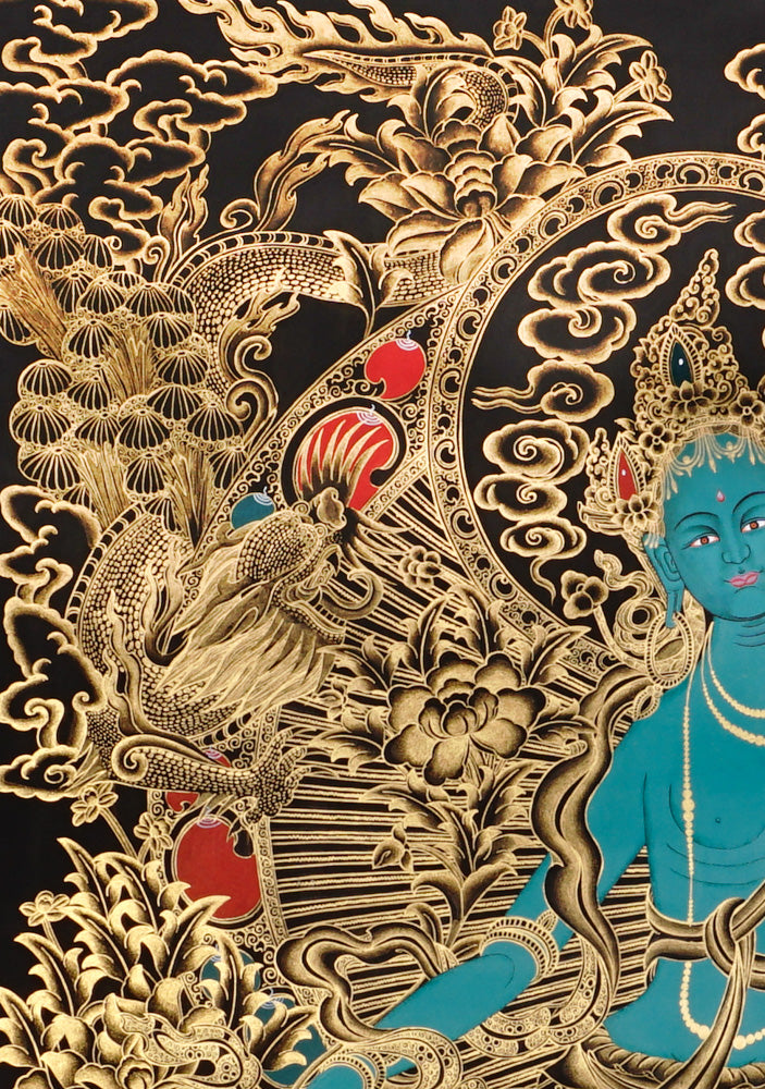 Gold-on-black Green Tara thangka showing the Buddhist goddess seated on a lotus throne surrounded by intricate gold floral and bird motifs.
