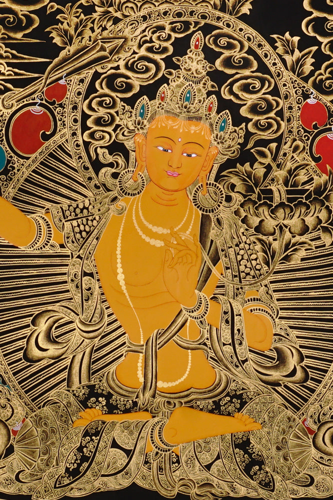 Gold-on-black Manjushri thangka depicting the Bodhisattva of wisdom holding the flaming sword and lotus scripture.