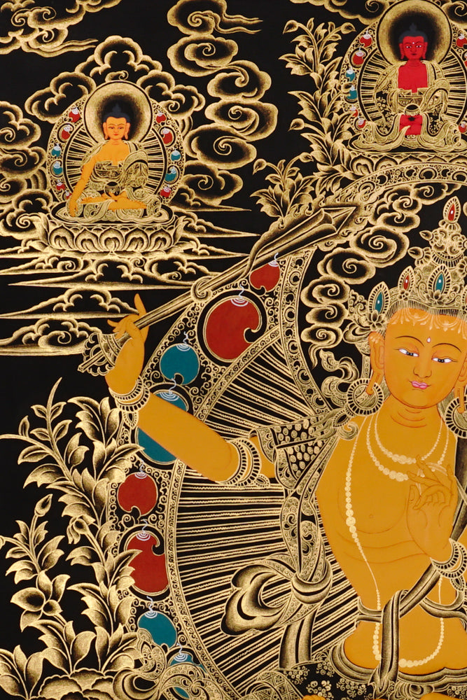 Gold-on-black Manjushri thangka depicting the Bodhisattva of wisdom holding the flaming sword and lotus scripture.