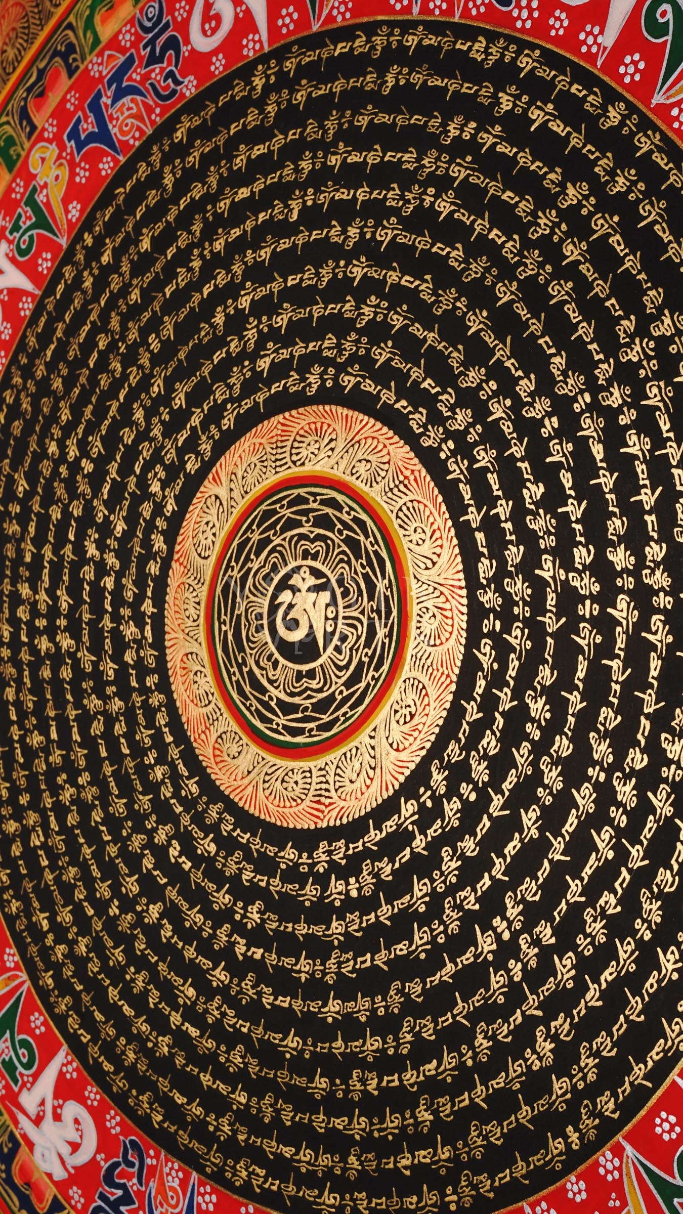 Tibetan mantra mandala thangka with black background, gold script rings, bold red outer mantra band, and floral corner decorations.