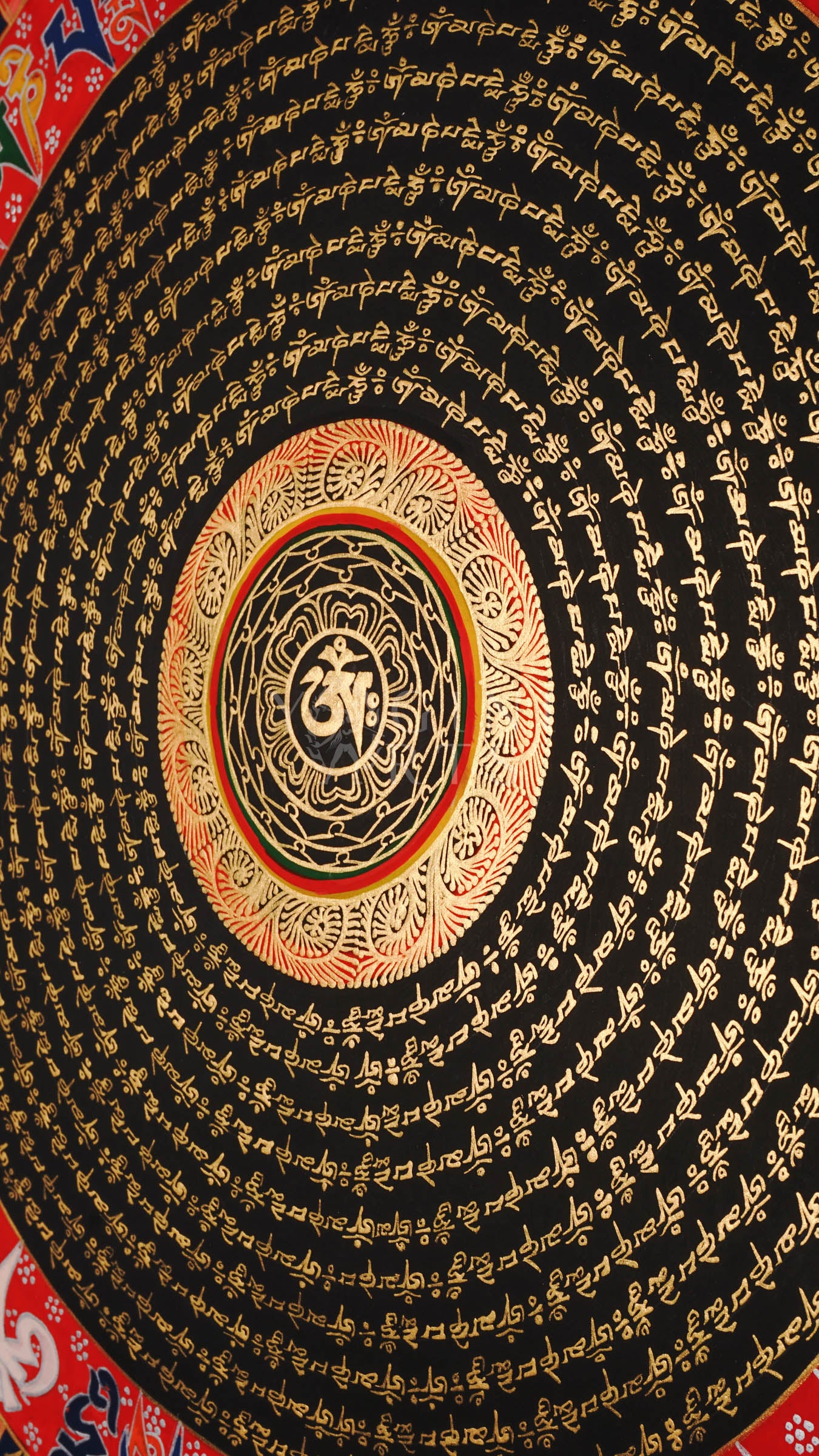 Tibetan mantra mandala thangka with black background, gold script rings, bold red outer mantra band, and floral corner decorations.