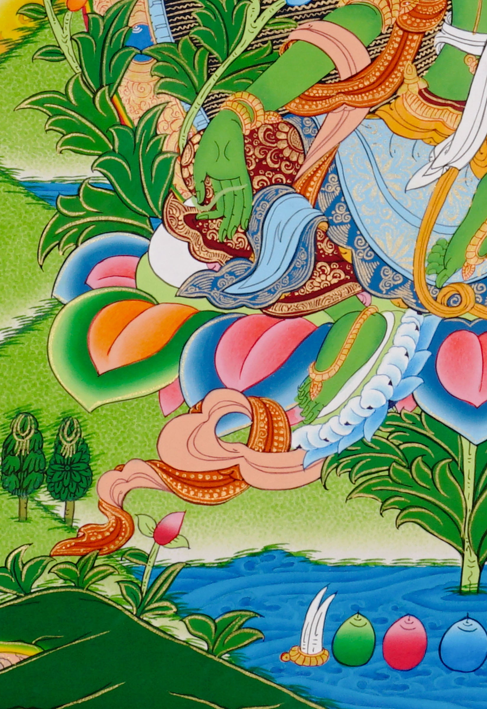 Green Tara thangka featuring the Tibetan Buddhist goddess seated on a lotus throne surrounded by flowers and sacred Himalayan landscape