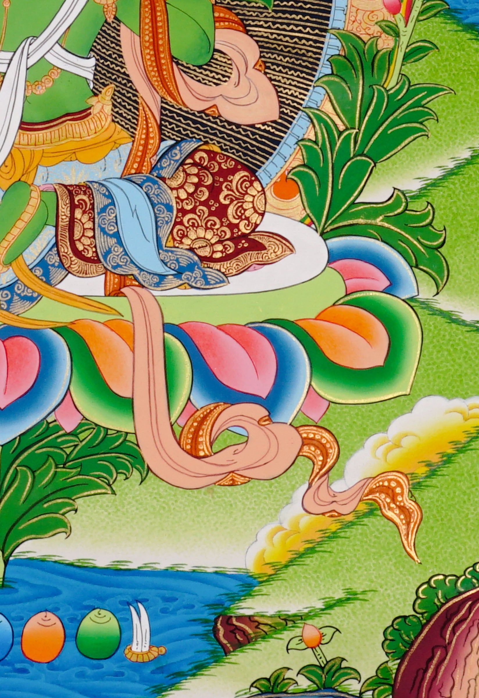 Green Tara thangka featuring the Tibetan Buddhist goddess seated on a lotus throne surrounded by flowers and sacred Himalayan landscape