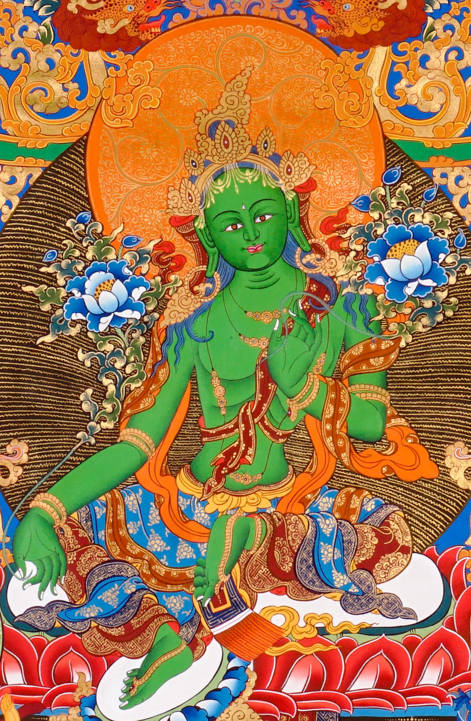 Hand-painted Green Tara thangka featuring the Tibetan Buddhist goddess seated on a lotus throne surrounded by sacred floral motifs and celestial symbolism
