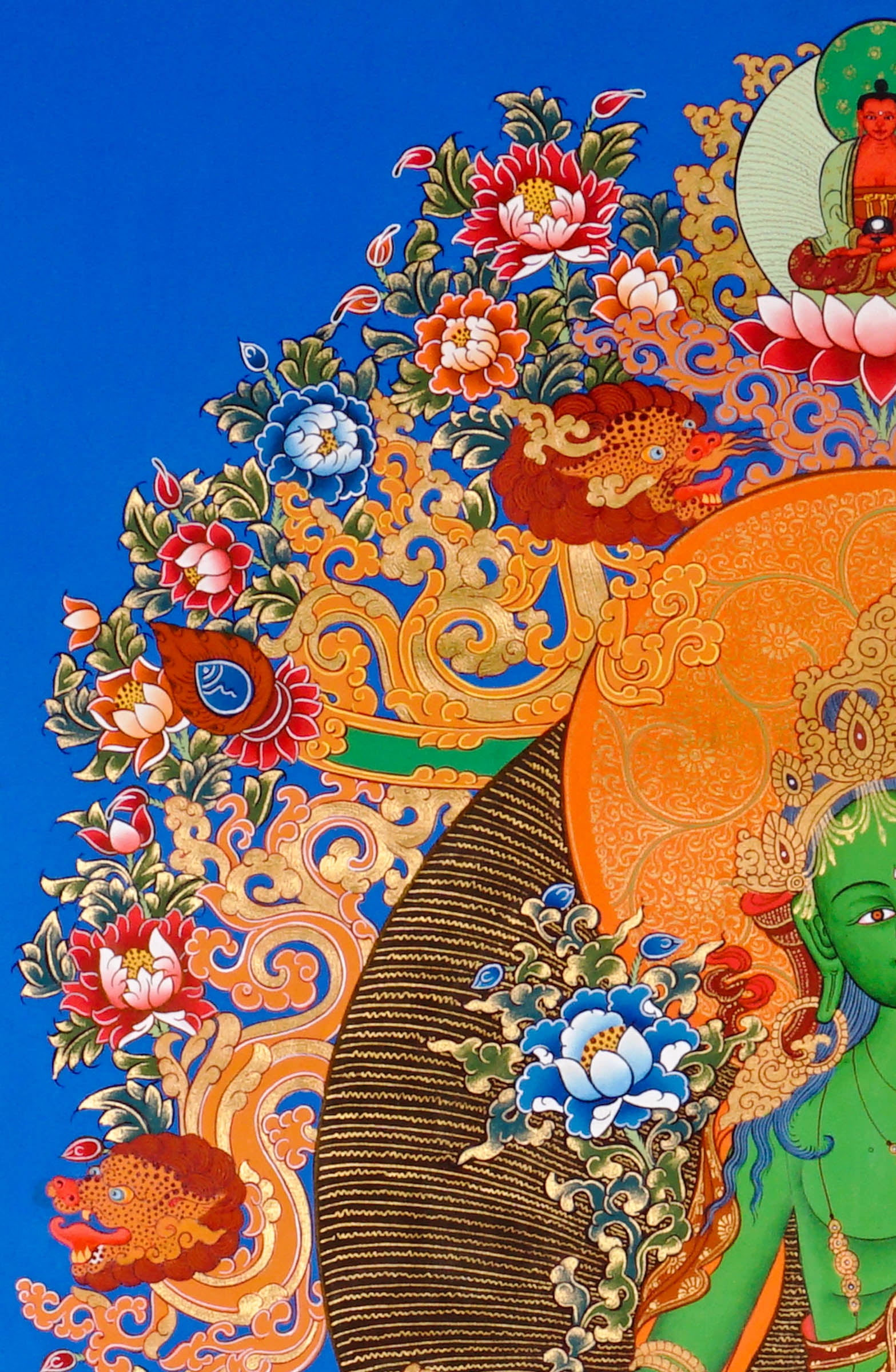 Hand-painted Green Tara thangka featuring the Tibetan Buddhist goddess seated on a lotus throne surrounded by sacred floral motifs and celestial symbolism
