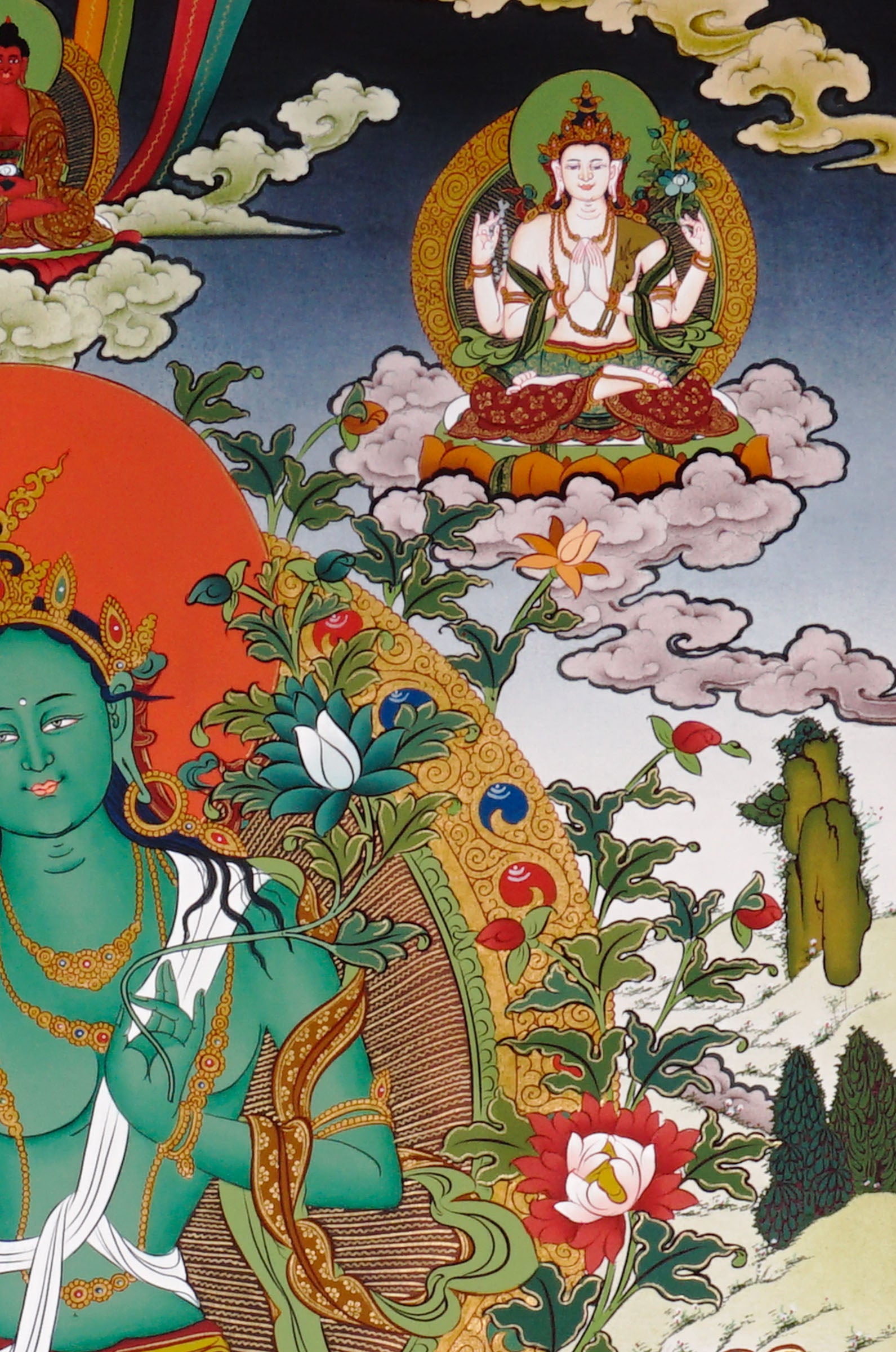 Hand-painted Tibetan Green Tara thangka featuring the Buddhist goddess seated on a lotus throne surrounded by sacred deities and floral Himalayan scenery
