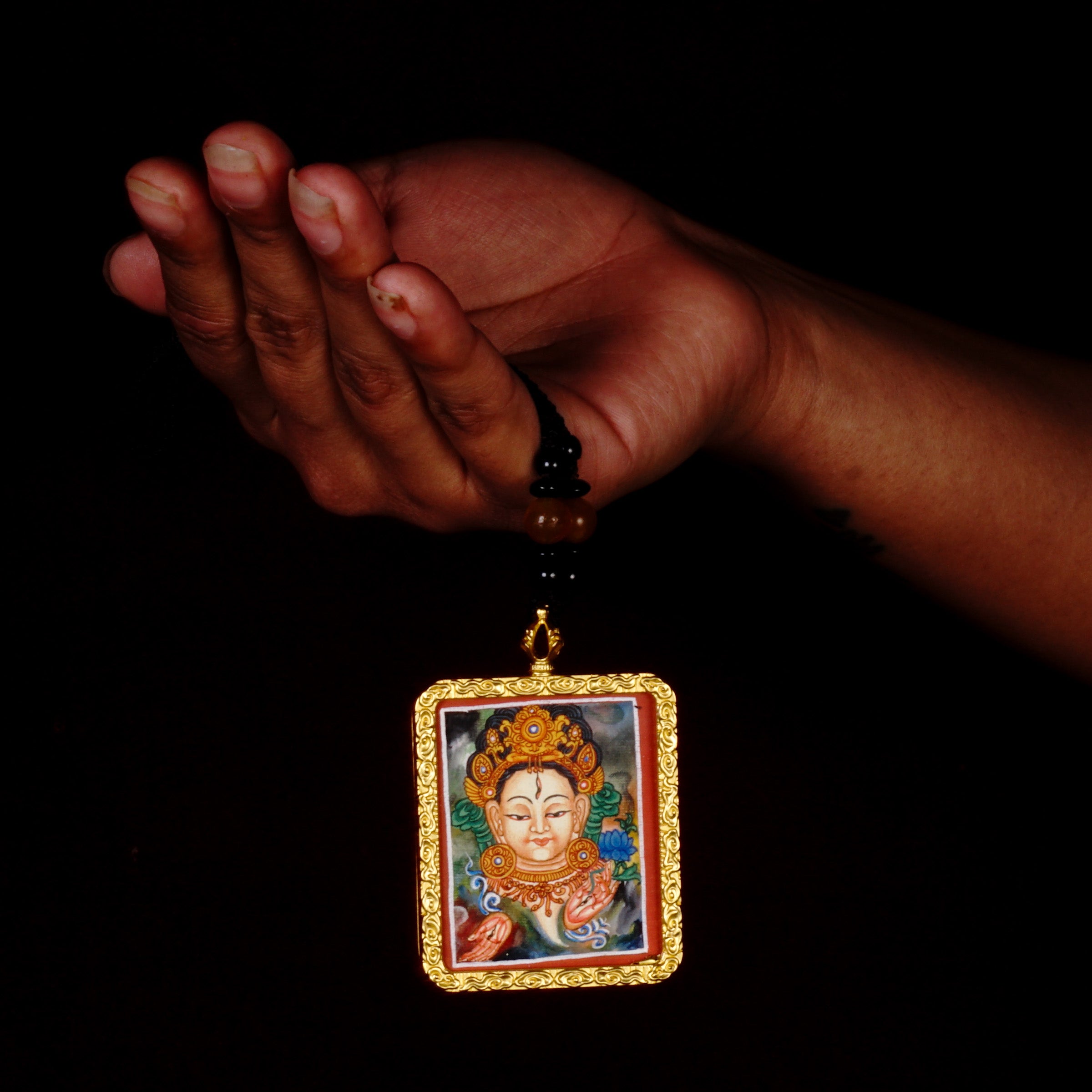 Hand-painted White Tara miniature Thangka pendant in gold-accented copper Ghau locket with black beaded cord.