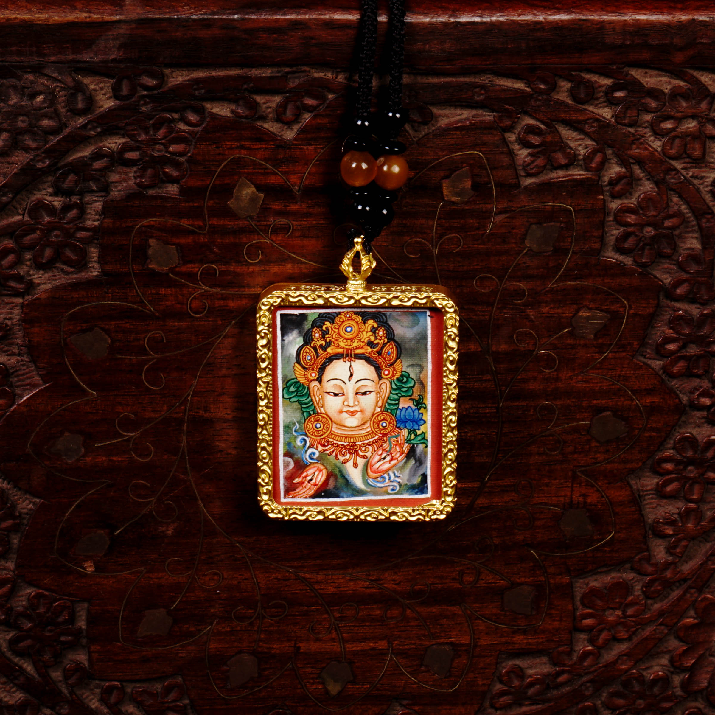 Hand-painted White Tara miniature Thangka pendant in gold-accented copper Ghau locket with black beaded cord.