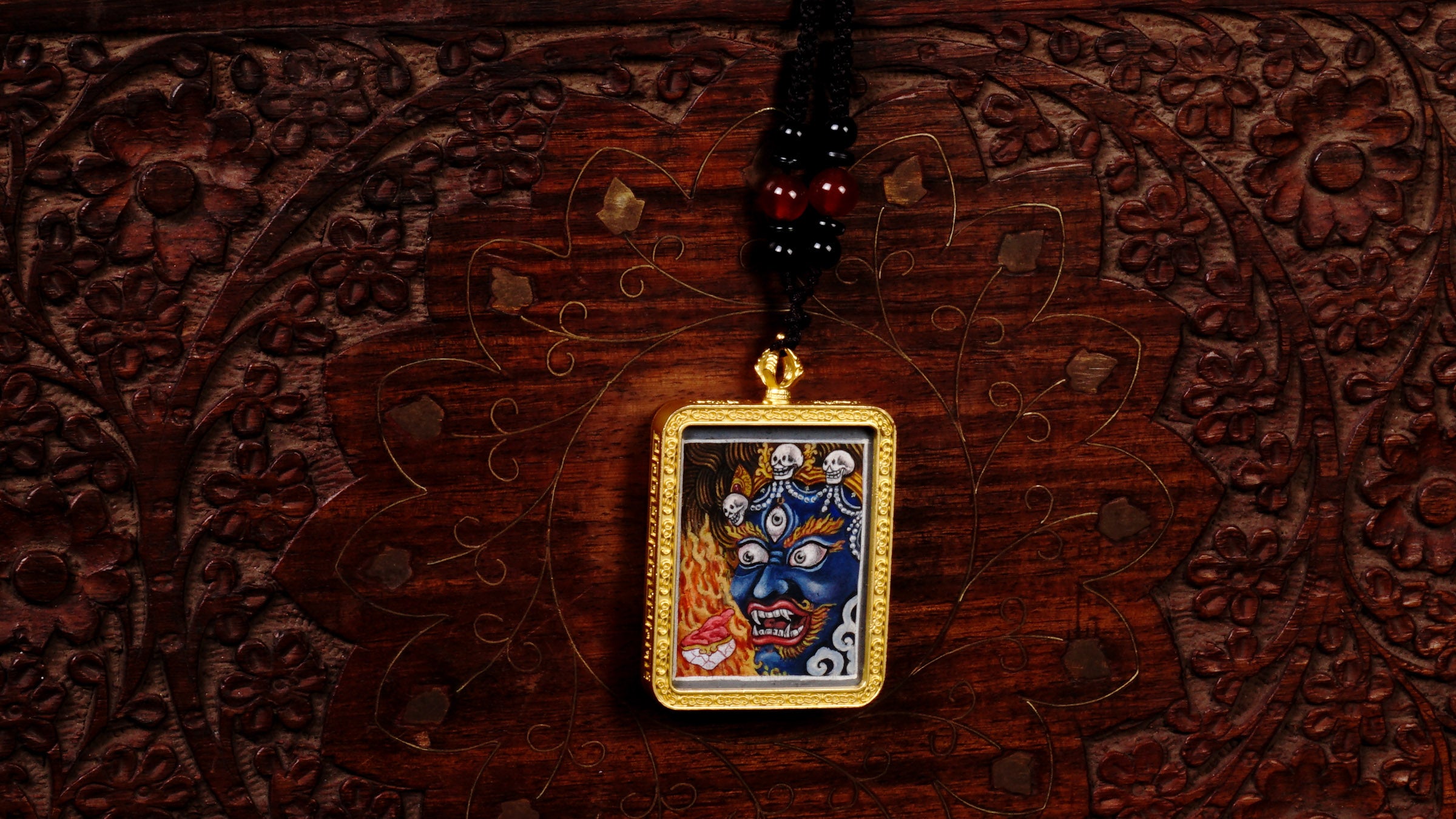 Hand-painted Mahakala miniature Thangka pendant in gold-accented copper Ghau locket with black beaded cord.