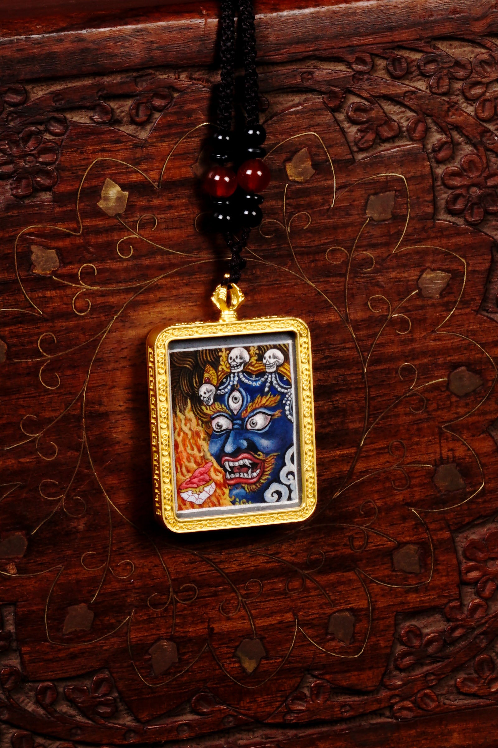 Hand-painted Mahakala miniature Thangka pendant in gold-accented copper Ghau locket with black beaded cord.