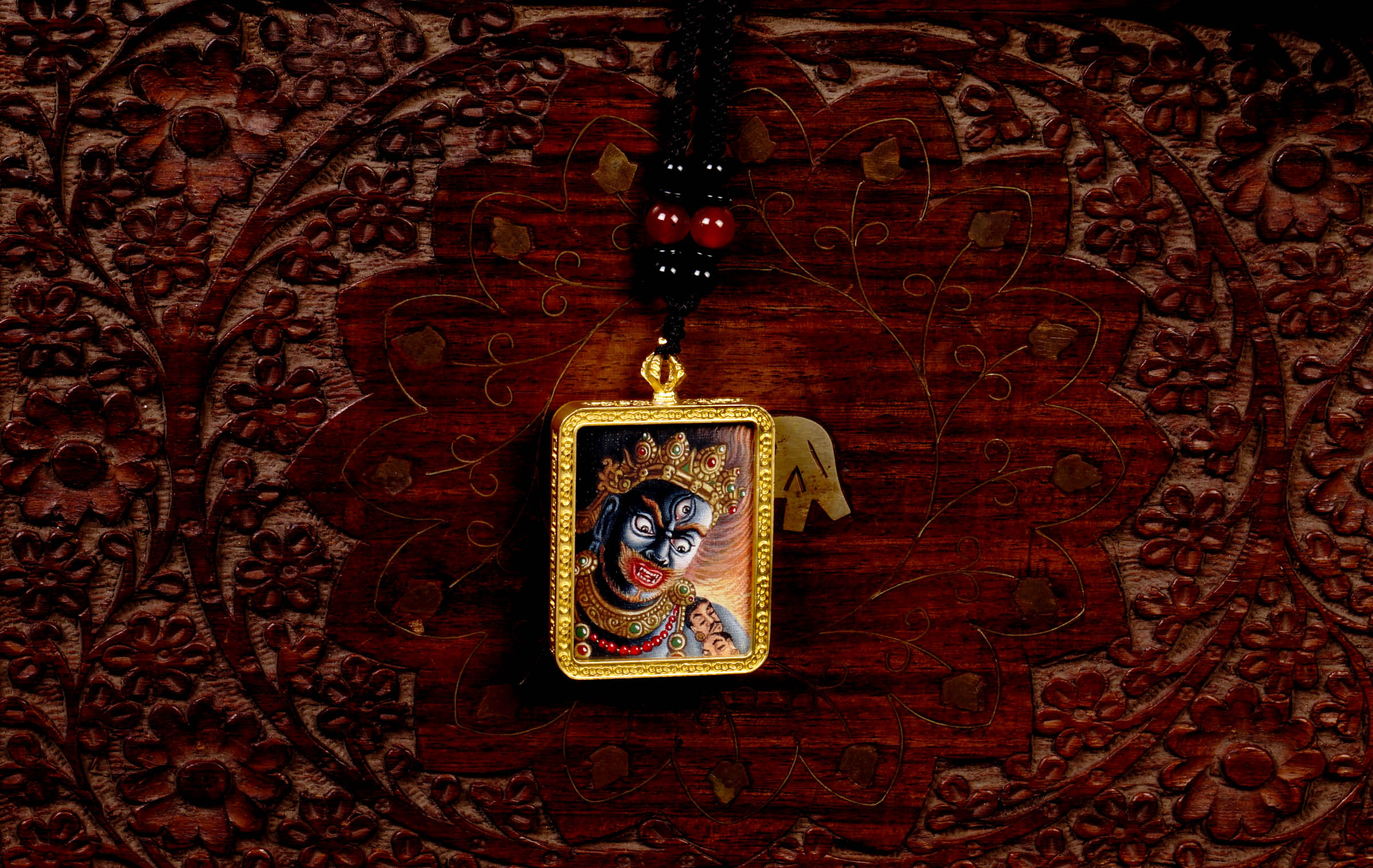 Hand-painted Mahakala miniature Thangka pendant in gold-accented copper Ghau locket with black beaded cord.