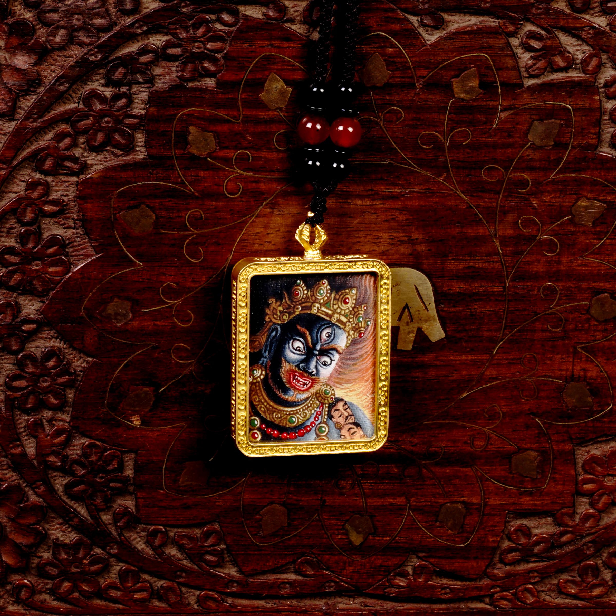 Hand-painted Mahakala miniature Thangka pendant in gold-accented copper Ghau locket with black beaded cord.
