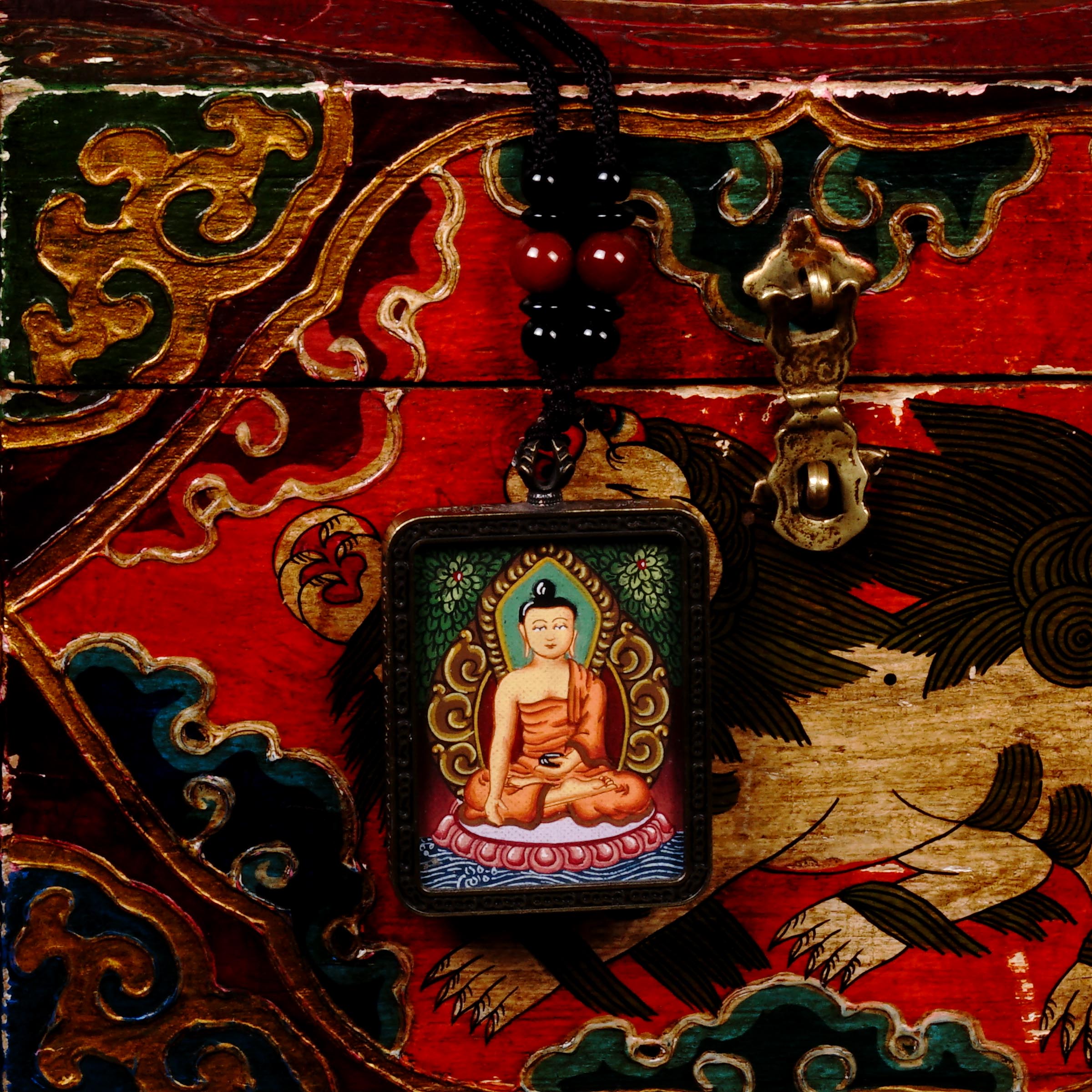Hand-painted Shakyamuni Buddha miniature Thangka pendant in gold-accented copper Ghau locket with black beaded cord.