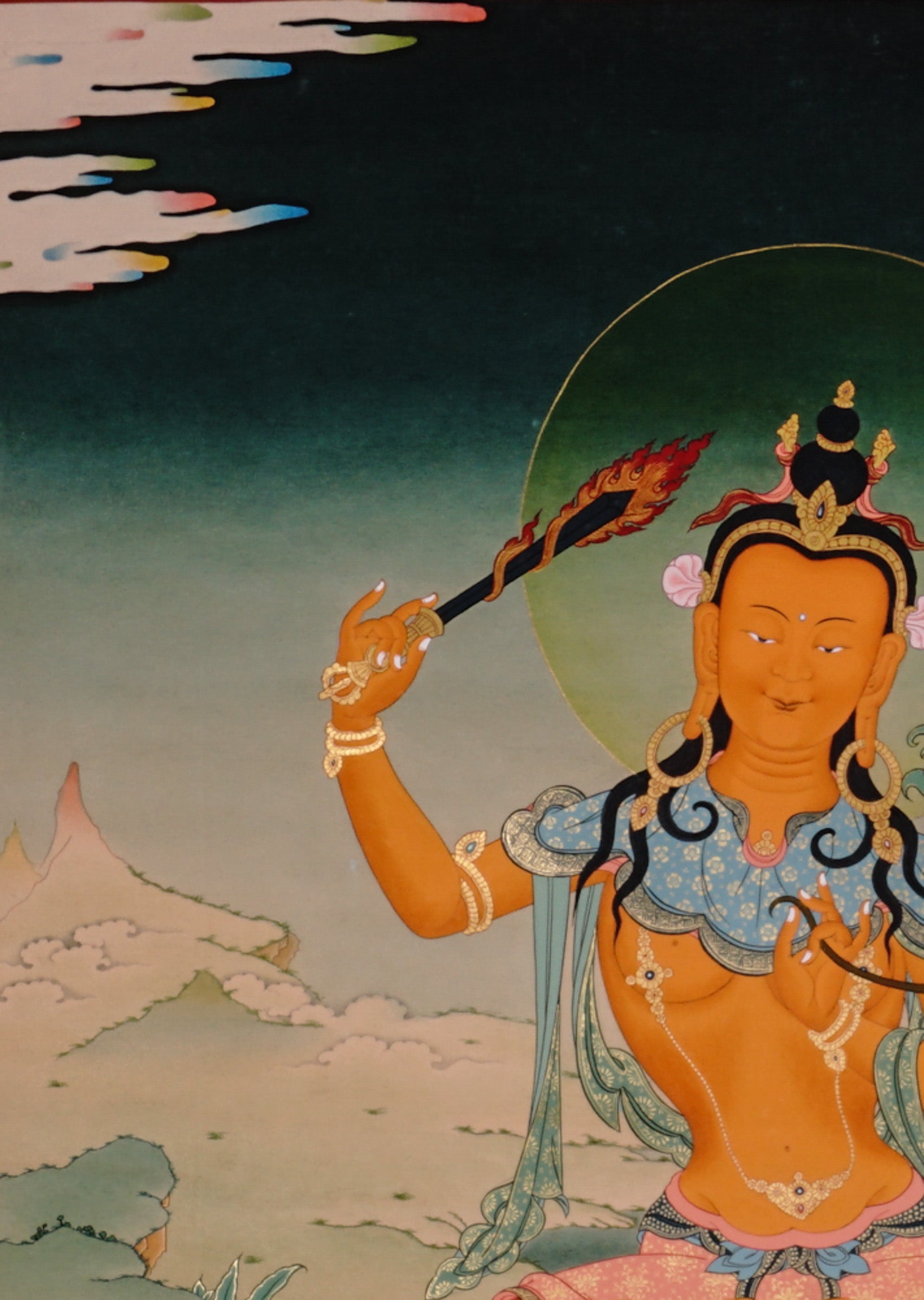 Handpainted Tibetan thangka of Manjushree Bodhisattva holding flaming wisdom sword and lotus scripture, seated on lotus throne in a serene Himalayan landscape.