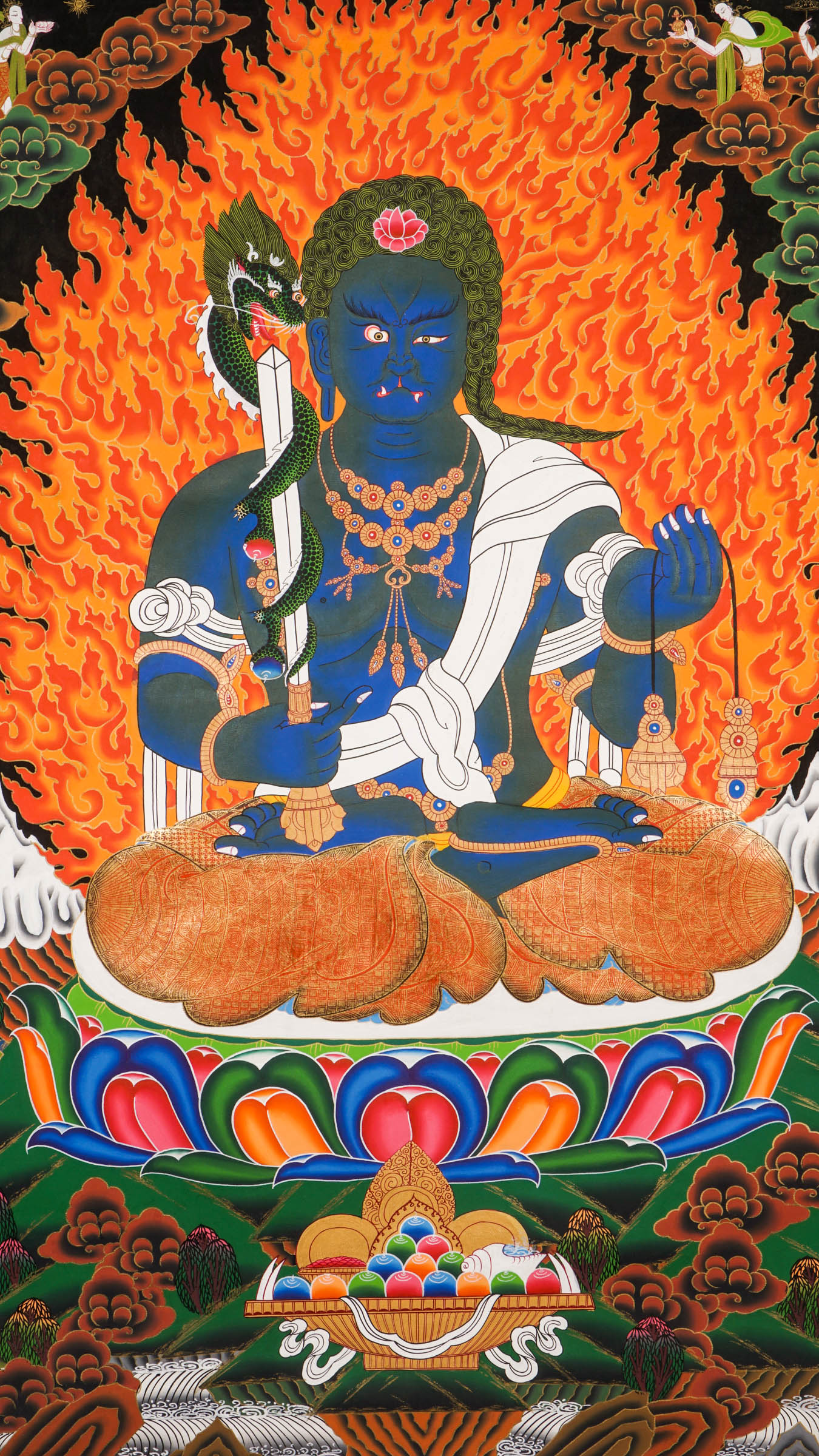 Traditional Tibetan thangka painting depicting Yamaraj, a blue-skinned wrathful deity seated on a lotus throne, surrounded by blazing flames, clouds, and symbolic ornaments against a dark background.