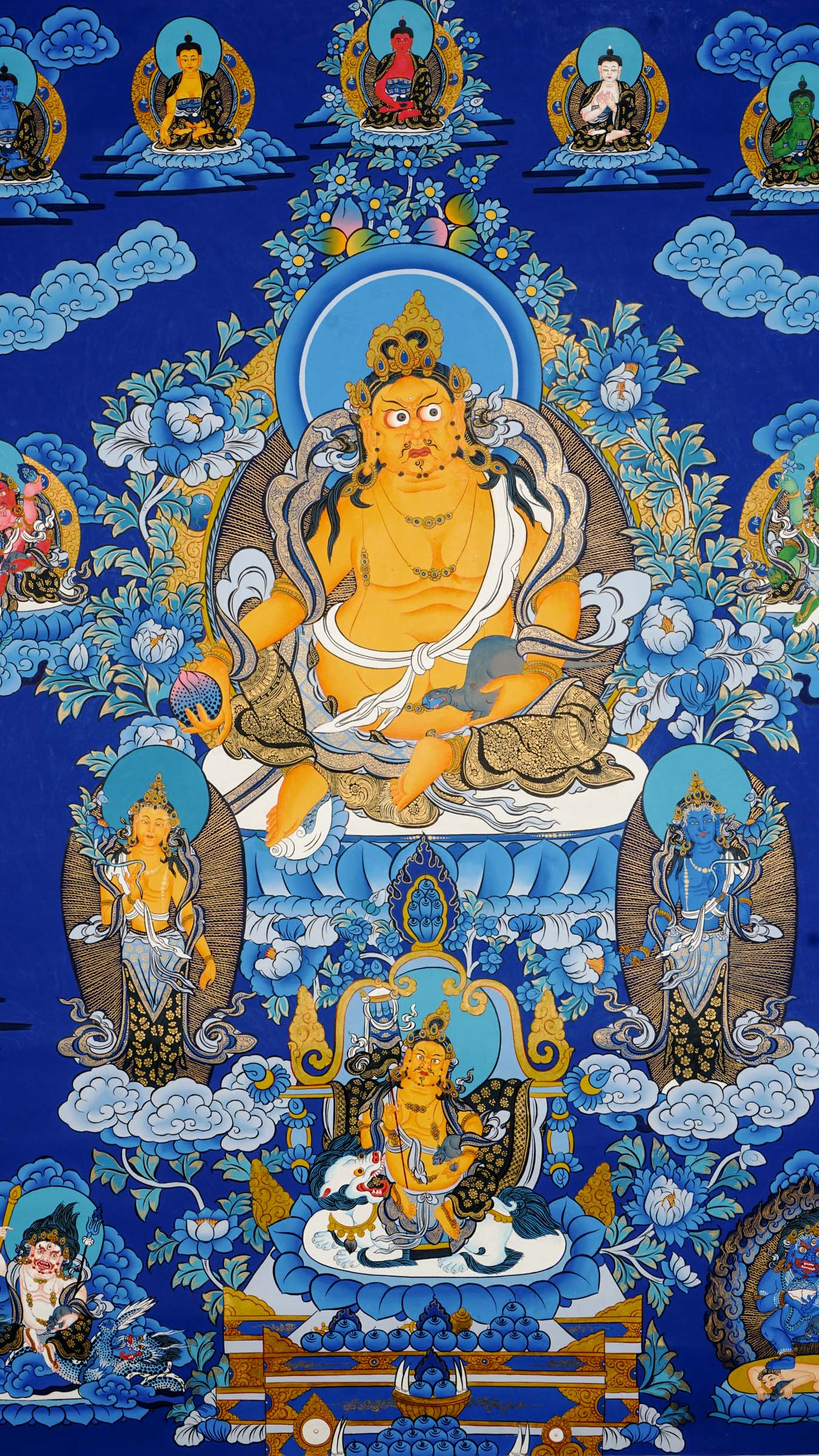 Tibetan thangka painting of Zambala, Buddhist god of wealth, handcrafted in Nepal with natural mineral pigments and 24k gold details, surrounded by deities and lotus motifs.