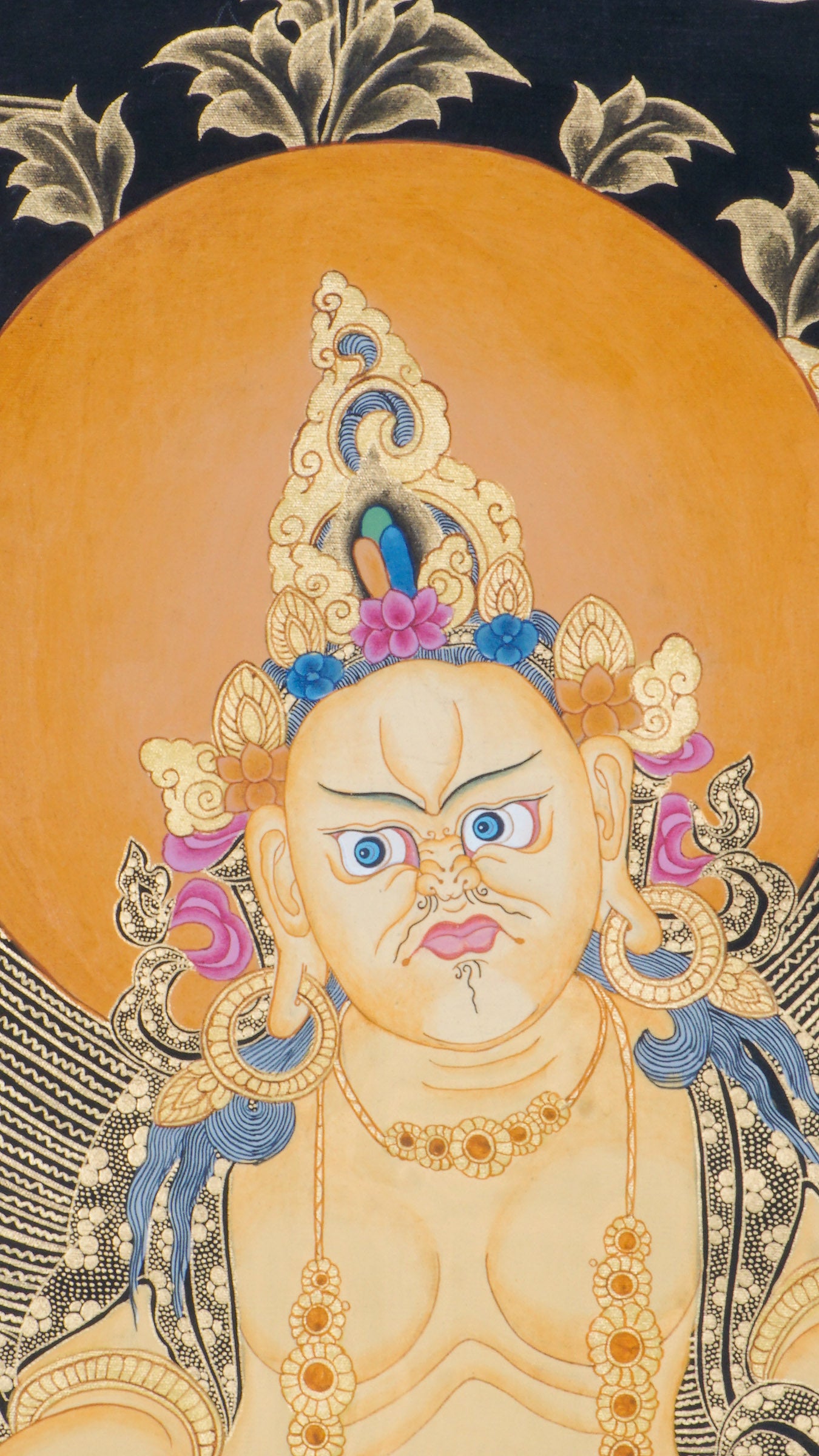 Zambala is a Tibetan Buddhist deity of wealth and prosperity. This genuine Thangka shows him seated on a lotus throne, holding a jewel-spouting mongoose and a symbol of fulfillment.