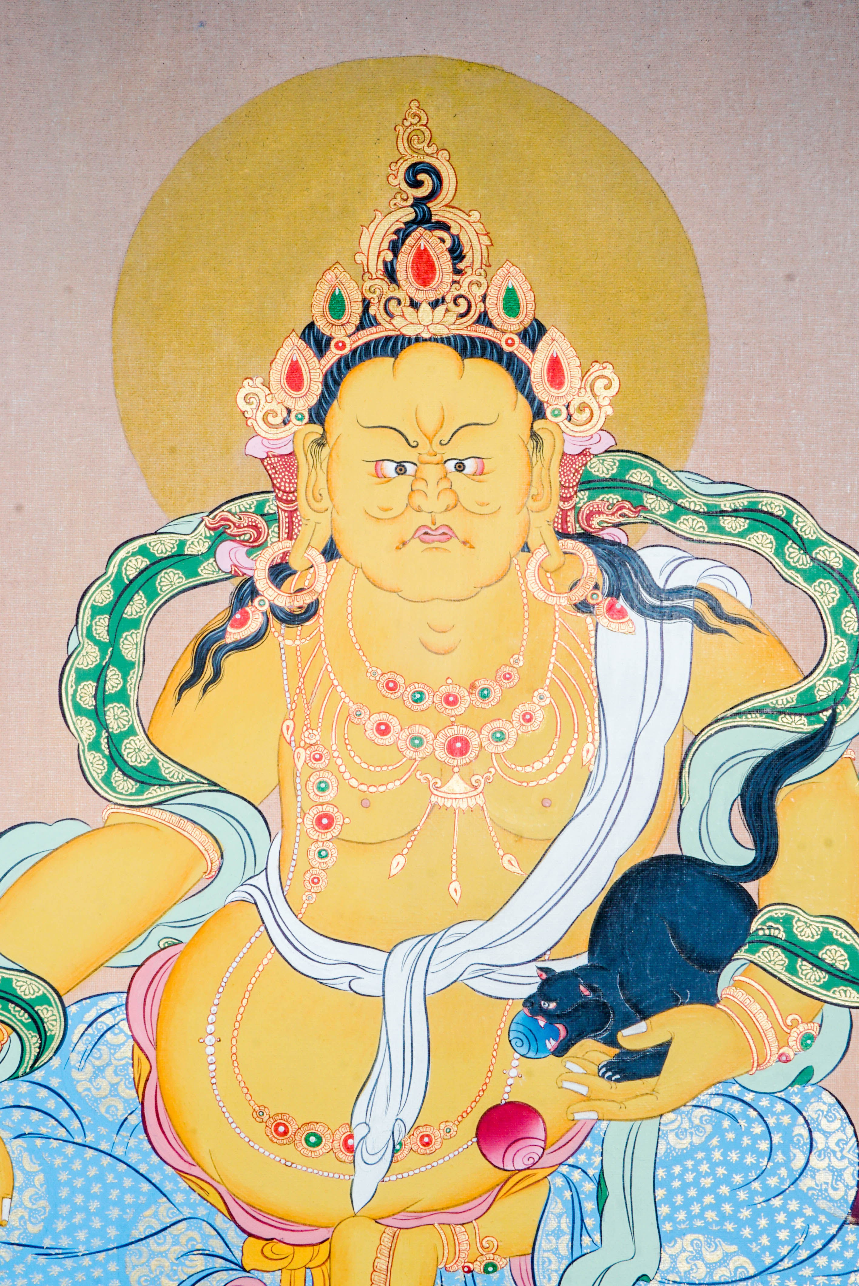 Zambala Thangka Painting features Zambala, the Tibetan Buddhist deity of wealth and prosperity, symbolizing abundance and success. Handcrafted by skilled artisans with intricate designs and natural pigments, this authentic Tibetan artwork embodies blessings of financial fortune and spiritual growth, making it a powerful symbol of prosperity and compassion.