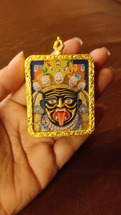 Hand-painted Zhaji Lhamo Ghau pendant in a gold-tone frame, handcrafted in Nepal using traditional Tibetan miniature painting techniques.