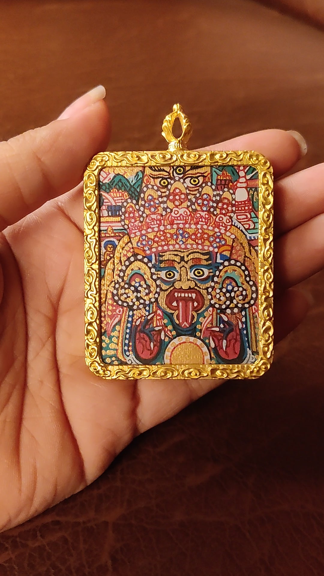Hand-painted Zhaji Lhamo Ghau pendant in a gold-tone frame, handcrafted in Nepal using traditional Tibetan miniature painting techniques.