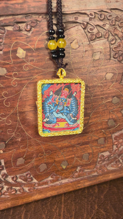 Hand-painted Yamantaka miniature Thangka pendant in gold-accented copper Ghau locket with black beaded cord.