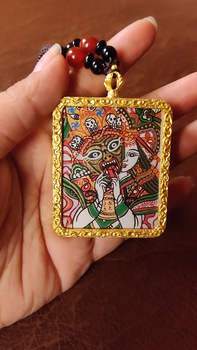 Hand-painted Zhaji Lhamo Ghau pendant in a gold-tone frame, handcrafted in Nepal using traditional Himalayan miniature painting techniques.