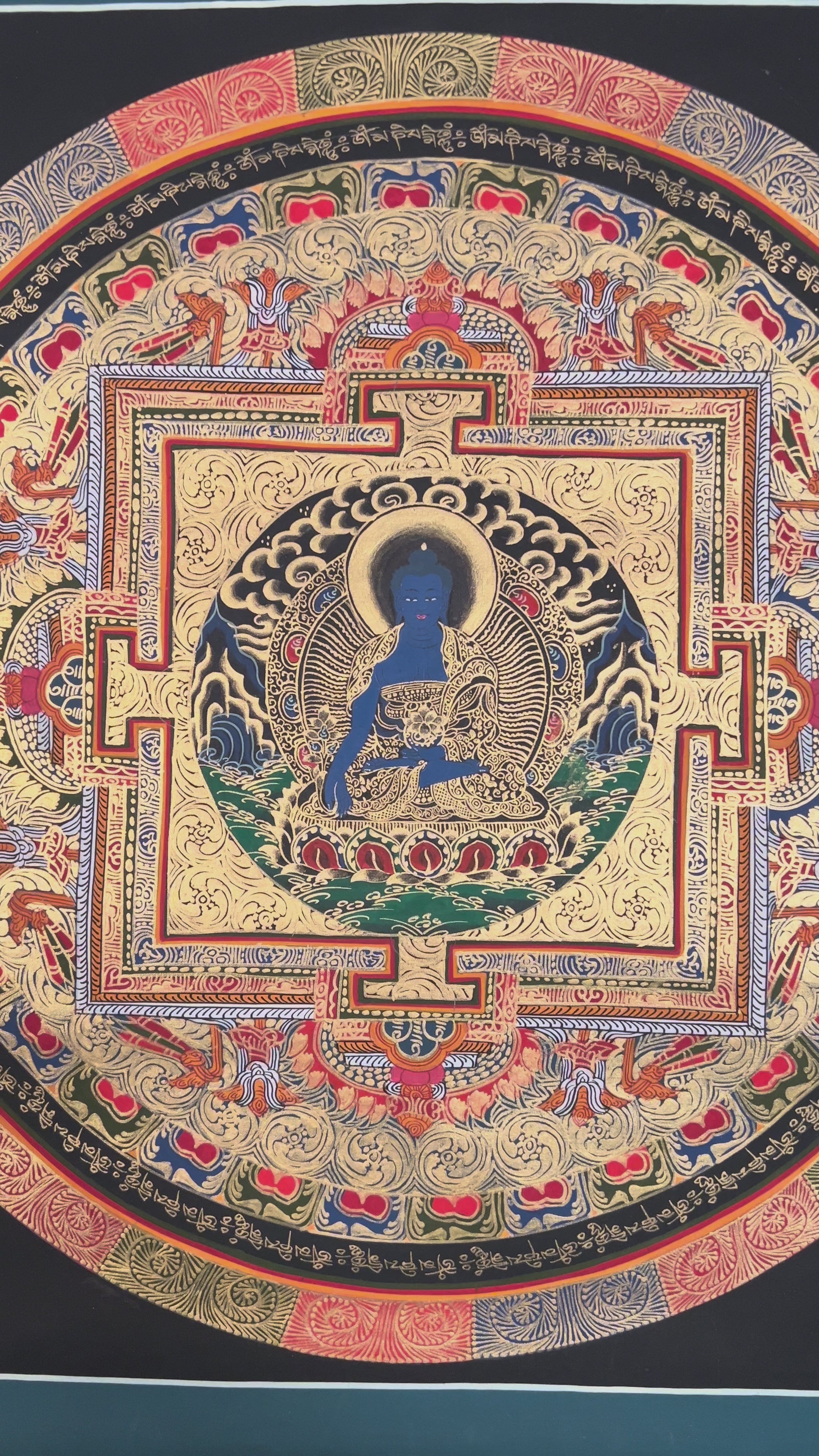 Hand painted Medicine Buddha Mandala thangka depicting blue healing Buddha seated within sacred geometric palace on dark background