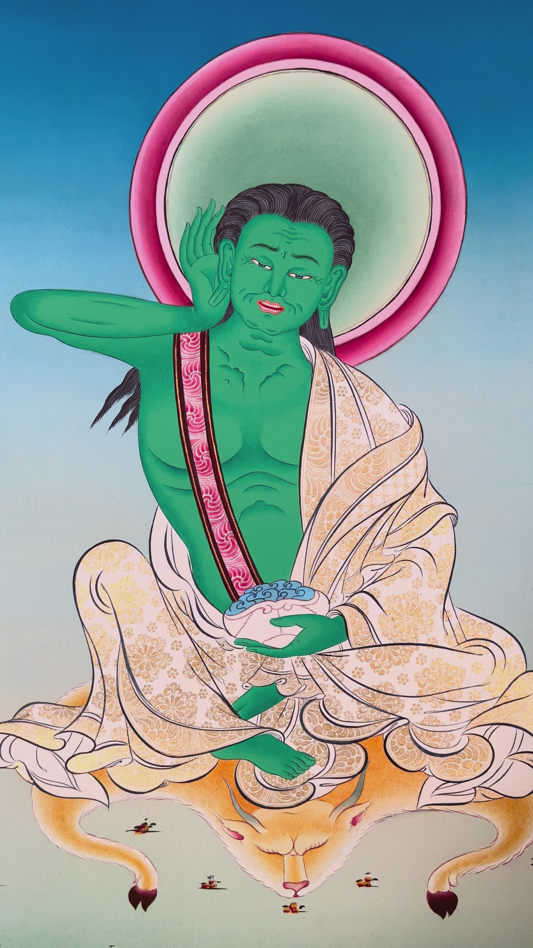 Hand-painted Milarepa Thangka showing Tibetan Buddhist yogi seated on deer skin with skull cup and listening gesture, blue background, traditional Himalayan art.