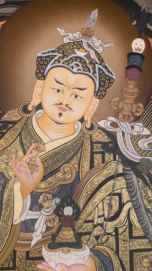 Hand-painted Guru Rinpoche Thangka featuring Guru Padmasambhava with White Tara and Amitayus, natural mineral pigments, gold detailing, and a traditional Himalayan landscape.