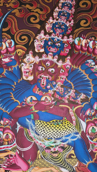 Heruka thangka showing a multi-headed, multi-armed wrathful tantric deity dancing on figures, surrounded by flames and intricate symbolic elements.