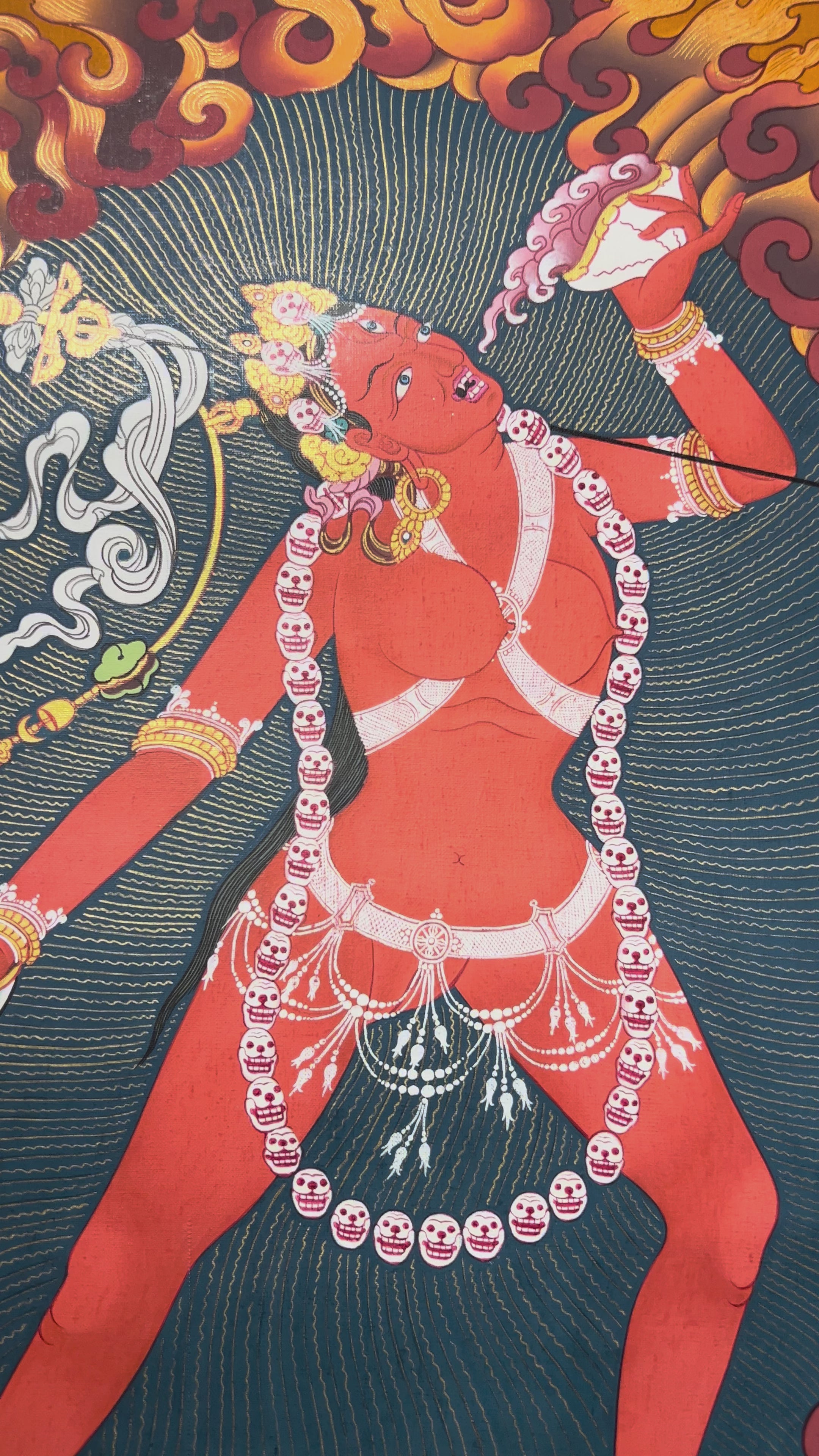 Vajrayogini thangka showing the red tantric Buddhist dakini dancing with skull garland, holding a kapala and ritual knife within a flaming aura.